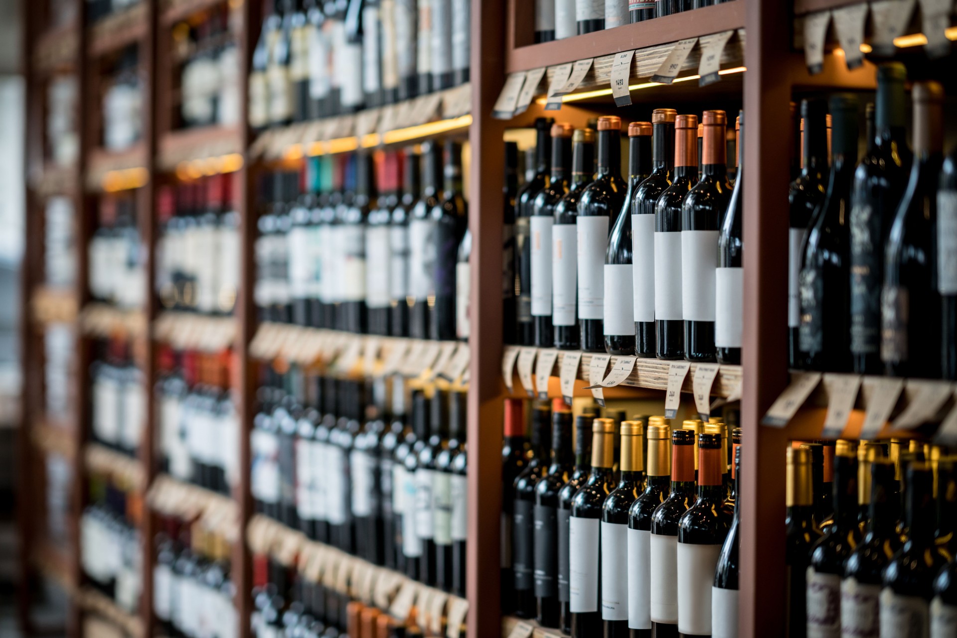 Close up of wine bottles on a shelf at a winery